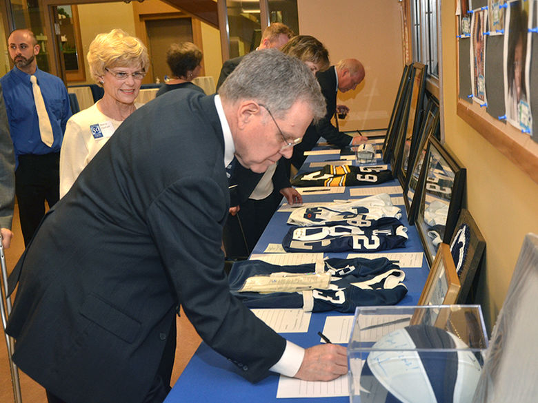 a campus supporter makes a bid on a silent auction item