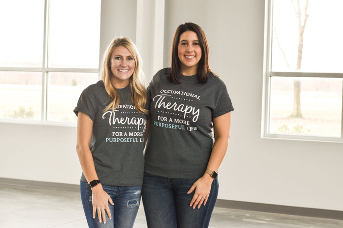 Holly Masters and Ali Izzo-Linton wearing t-shirts that read occupational therapy for a more purposeful life.