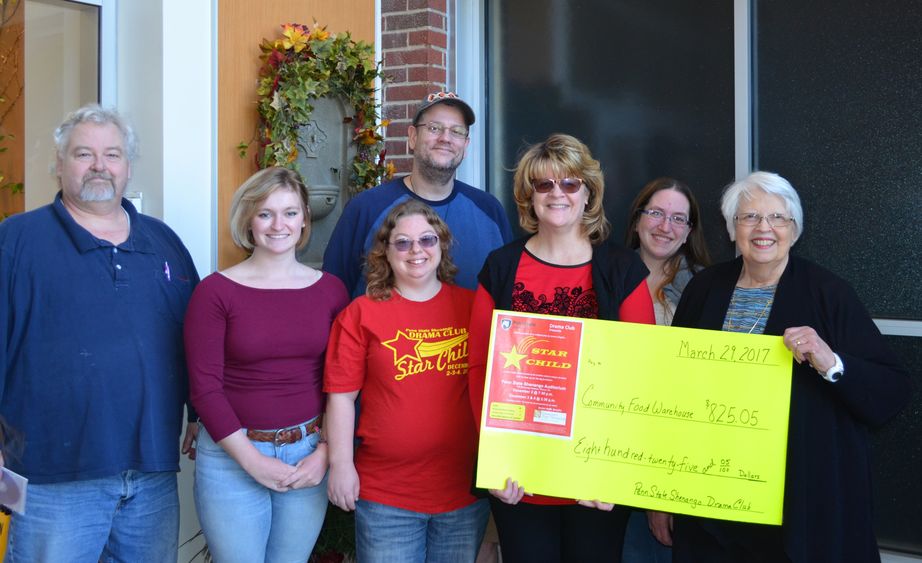 Penn State Shenango Drama Club presents a check to the Community Food Warehouse