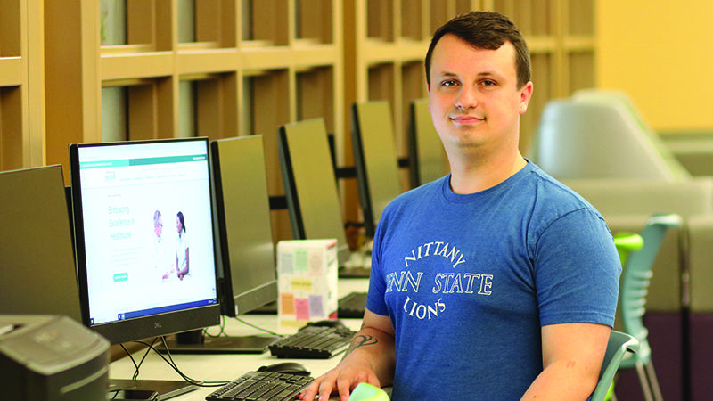 Joshua Marshall sitting at a computer