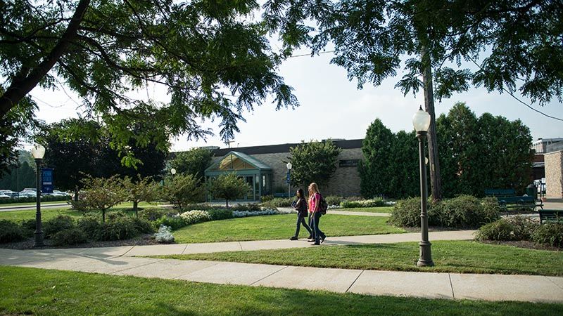 Two students walk outside library