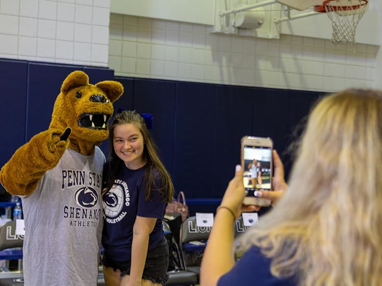 Student taking photo with Nittany Lion Mascot