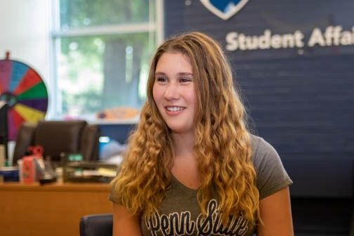A young woman with wavy blond hair in the Student Affairs office at Penn State Shenango.
