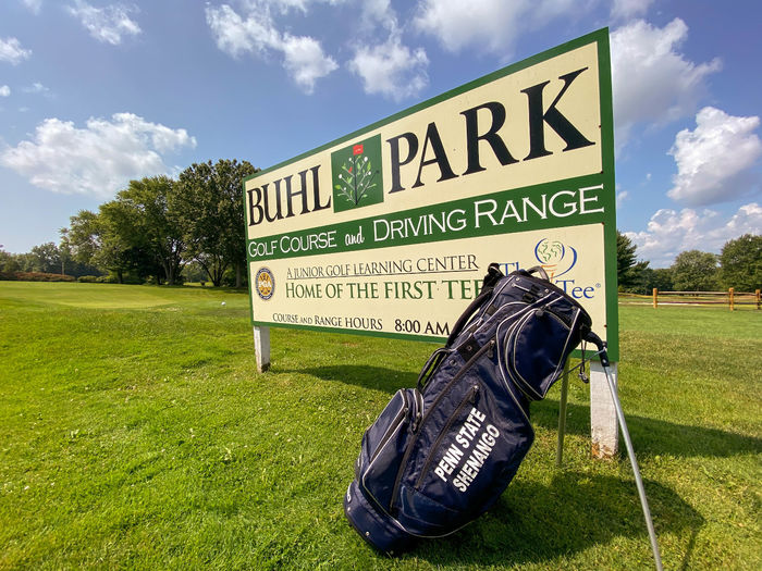 Penn State Shenango golf bag in front of Buhl Park Golf Course sign