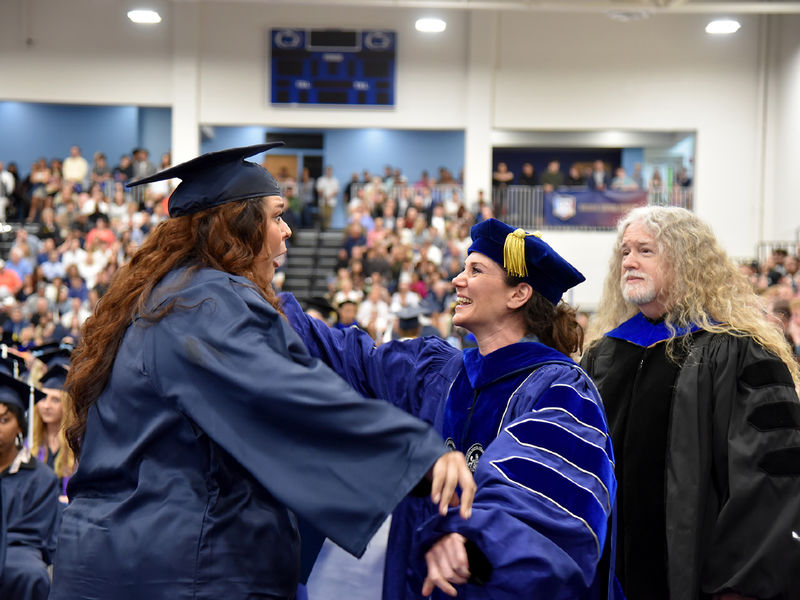 A Penn State Altoona graduate is congratulated by faculty