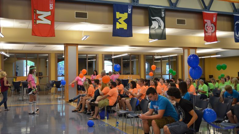 New incoming freshman listen to Student Lion Leader Kate Erdesky in the Great Hall