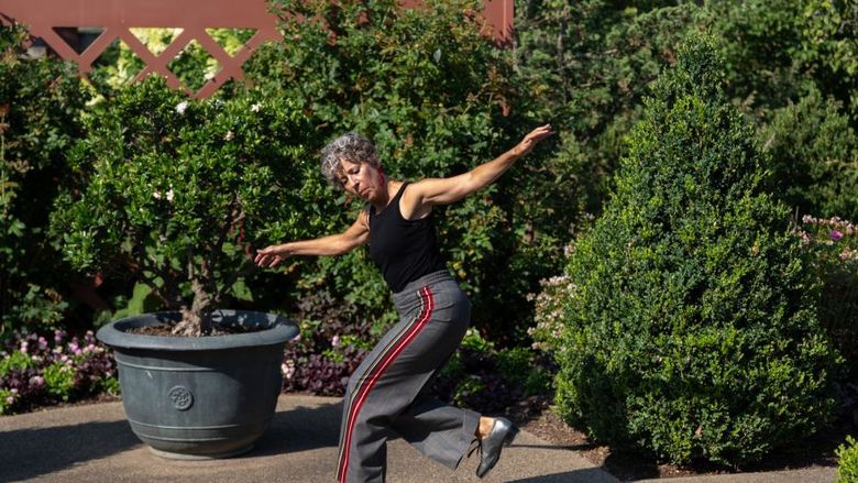 Woman tap dancing among trees