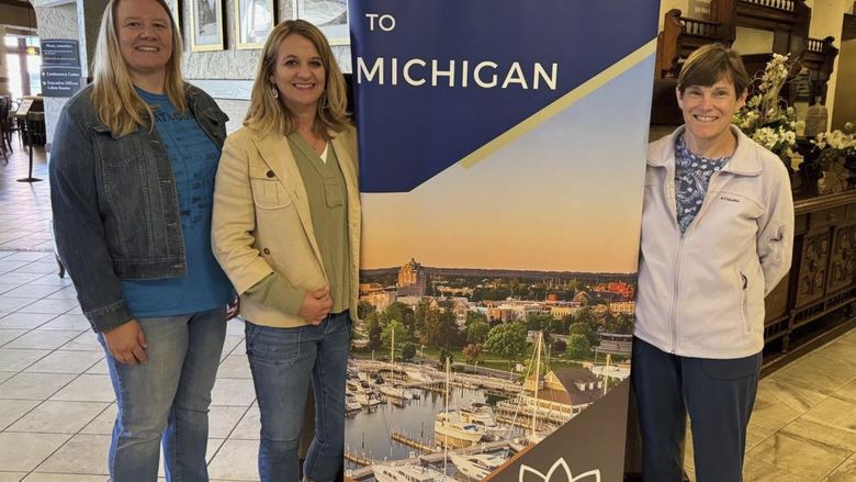 Angela Pettitt, Tammy Divens, and Kathy Shaffer pose with a Lilly Conference sign