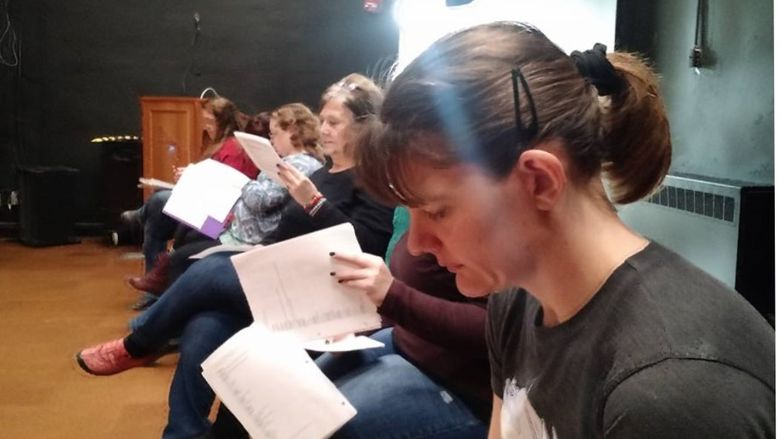 Several women study scripts for the upcoming drama production at Penn State Shenango