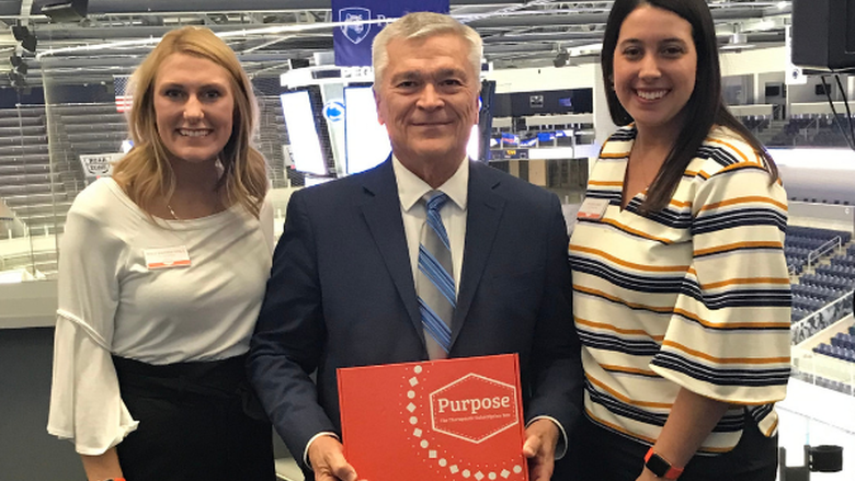 Penn State President Barron standing with student company founders of Purpose Therapy Box