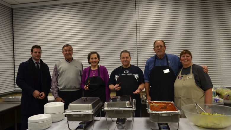 Campus Director Dr. Carrick and alumni and advisory board members help serve spaghetti at 2014 fundraiser
