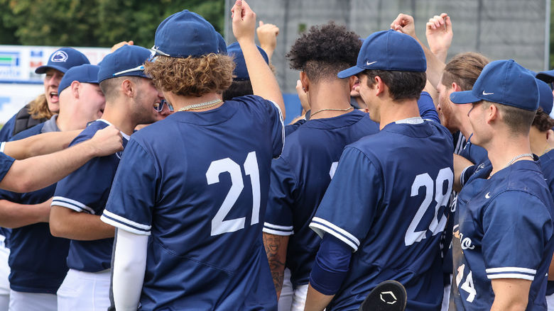 Members of a baseball team huddle together