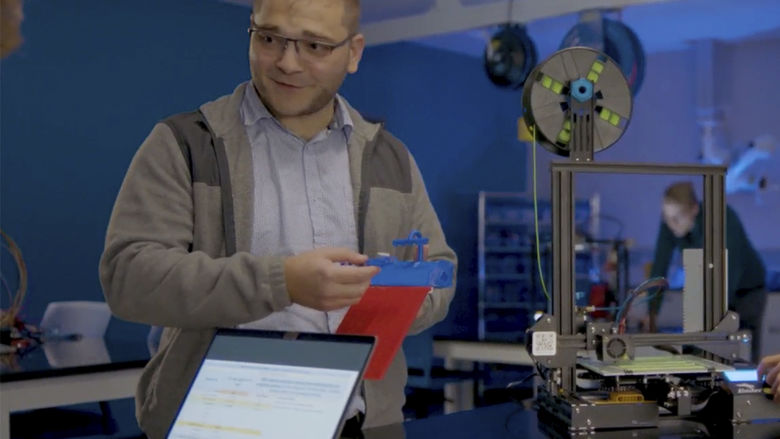 Matthew Caputo demonstrating how a 3D printer works