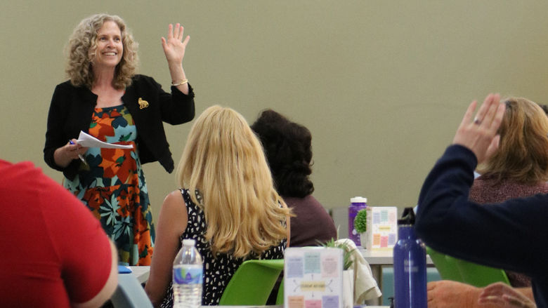 Carey McDougall waves to faculty and staff members