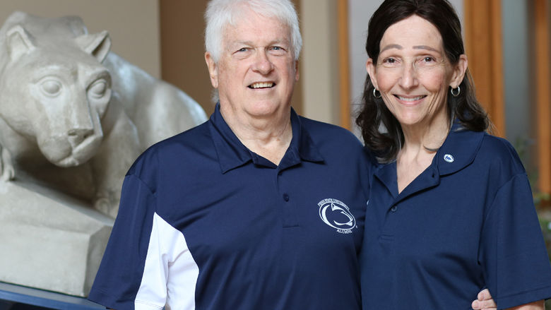 Jo Anne and John Carrick pose in front of the Nittany Lion Shrine