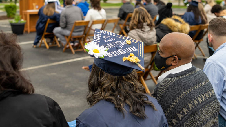 Graduate's cap decorated to say "Difficult roads often lead to beautiful destinations" 