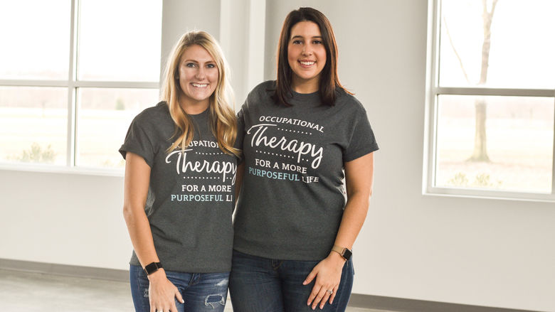 Holly Masters and Ali Izzo-Linton wearing t-shirts that read occupational therapy for a more purposeful life.