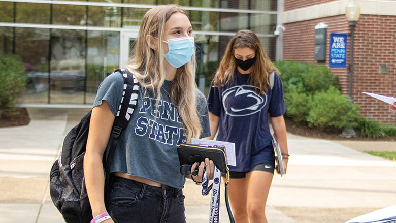Two women in masks outside of atrium