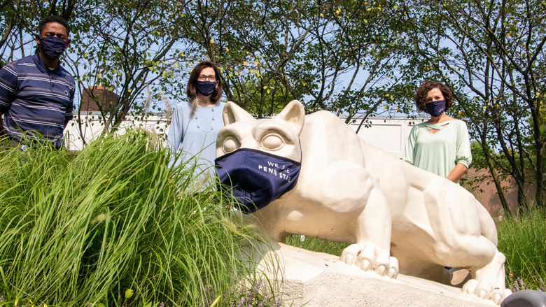 Bill Dungee, Jo Anne Carrick and Jammie Clark behind Lion Shrine that is wearing a mask