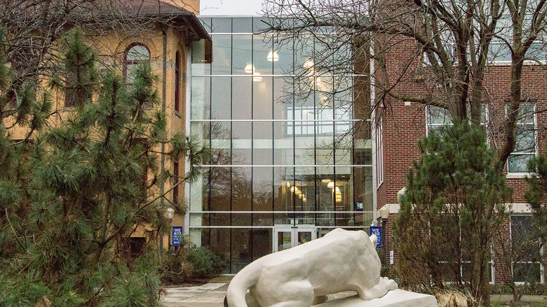 The Lion Shrine overlooks the atrium between Lecture Hall and Sharon Hall on a fall day