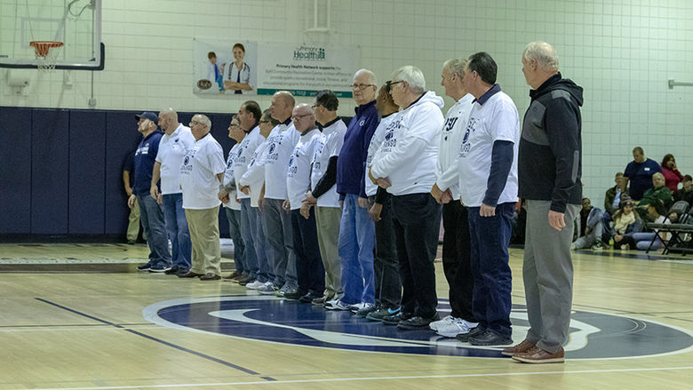 At halftime, alumni men's basketball players were honored in the center of the court. 