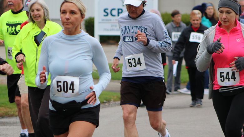 Runners and walkers outdoors wearing bib numbers at the Jane Williams 5k