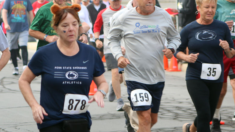 People running in the foreground and walking in the background