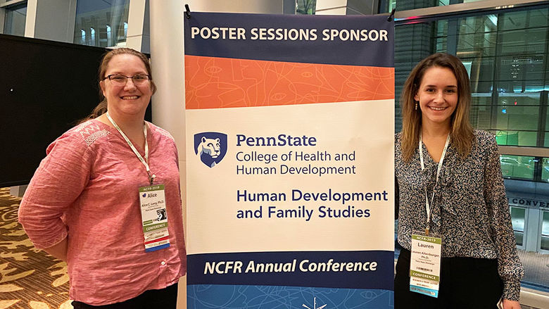 Two female instructors in front of a poster that reads Poster Sessions Sponsor Penn State College of Health and Human Development Human Development and Family Studies NCFR Annual Conference.