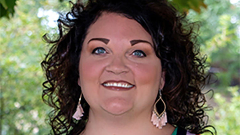 A brunette wearing a colorful blouse