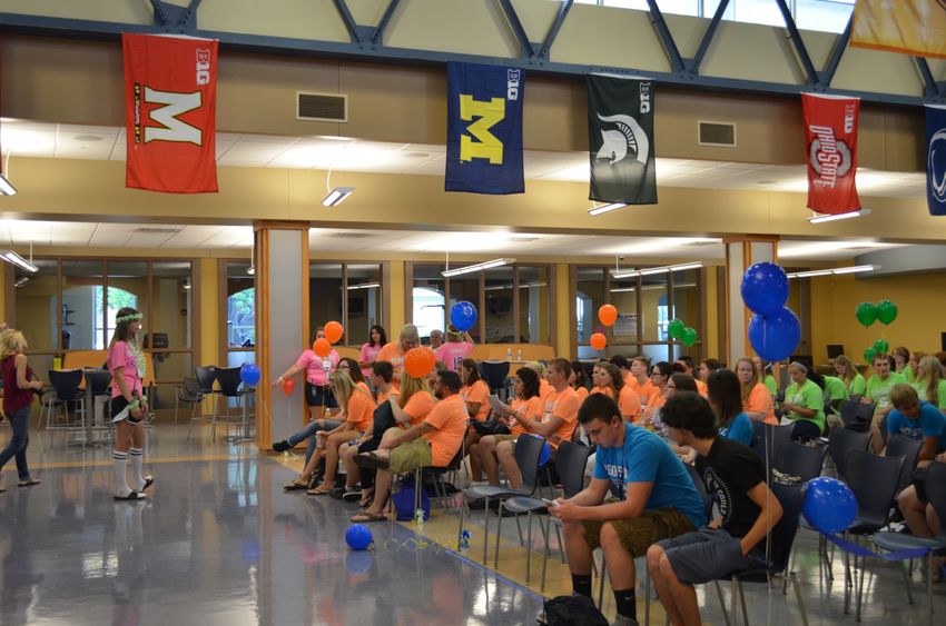 New incoming freshman listen to Student Lion Leader Kate Erdesky in the Great Hall