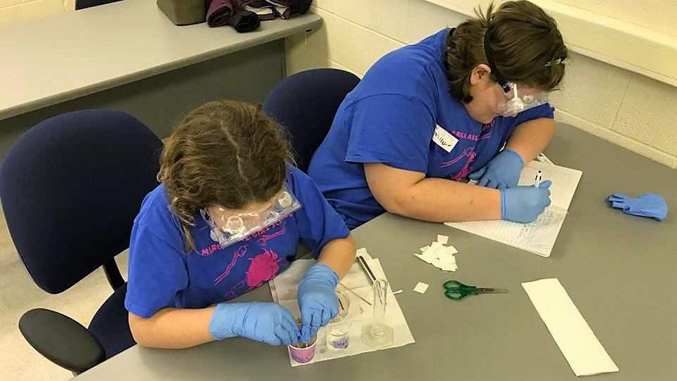 Two young girls working on a project in a Penn State Shenango classroom in 2017.