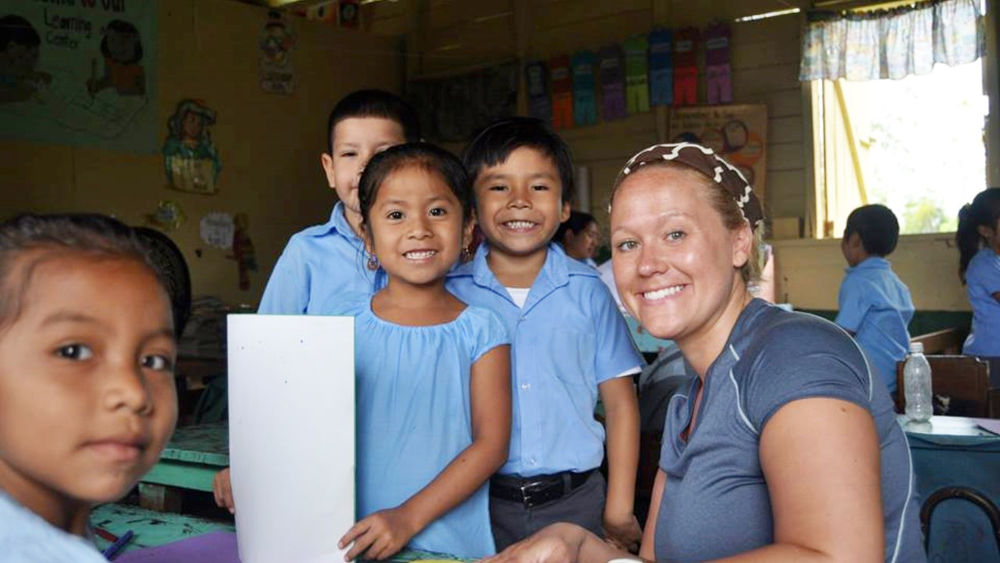 Children from San Pedro, Columbia, Belize with a Shenango campus student.