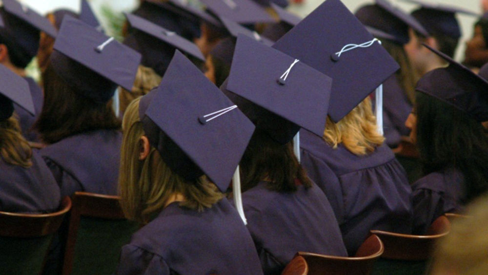 Penn State Shenango graduates' caps seen from above 