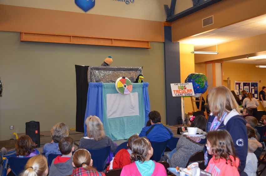 Children gather to watch much aniticpated puppet show during Earth Fest 2015