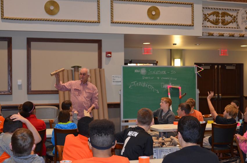 A Penn State faculty member shows students from Sharon schools how to build somethings strong using paper towel roles and duct tape. 