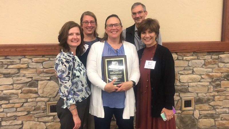 Three women and one man pose with Dr. Jen Jewell who received a PPTA award