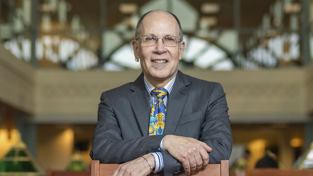 Picture of professor Champagne standing inside of a building.
