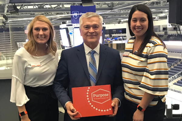 Penn State President Barron standing with student company founders of Purpose Therapy Box