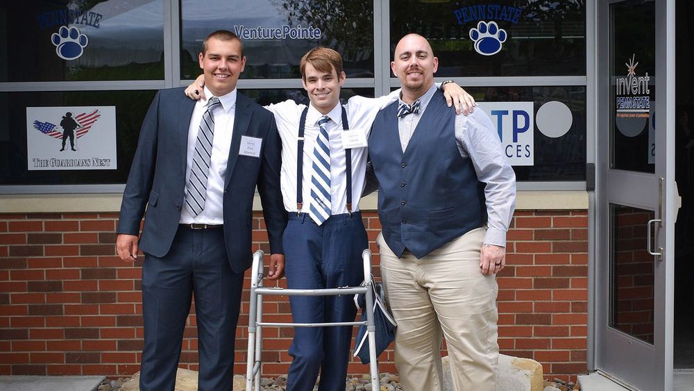 Three men standing in front of a building at the eCenter@LindenPointe