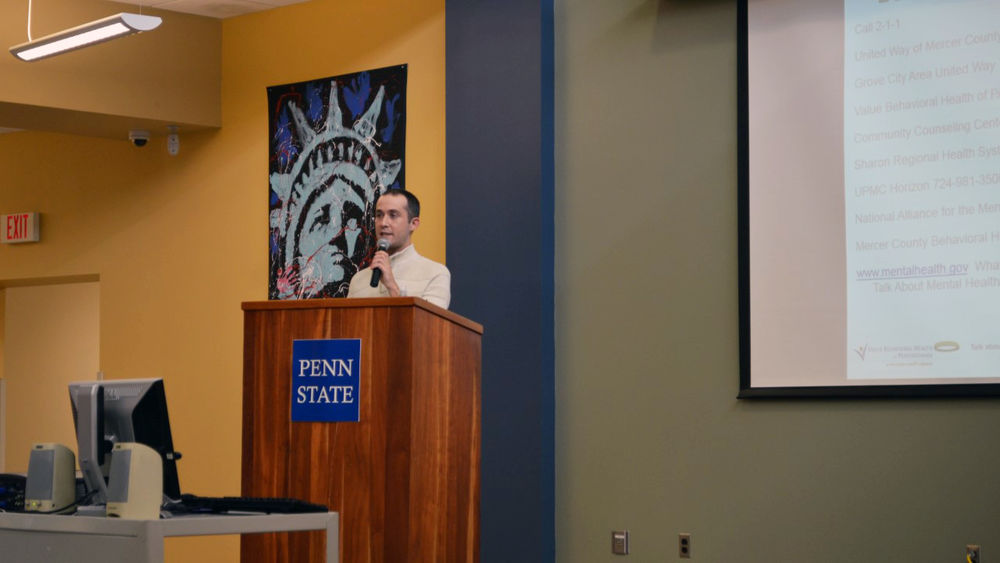 Penn State alumnus Jack Luchette stand at the podium in the Great Hall