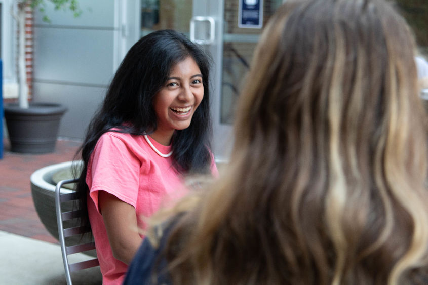 Female student laughing with a friend