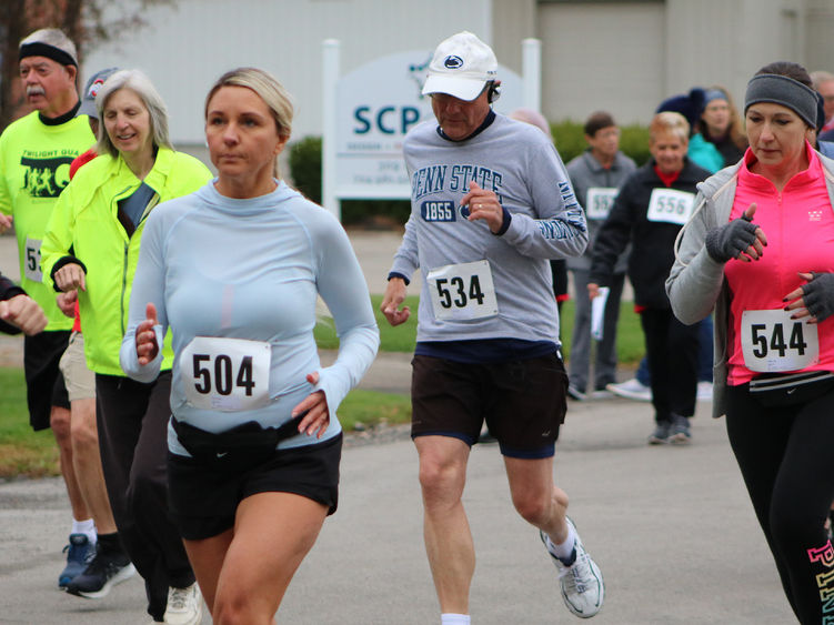 Runners and walkers outdoors wearing bib numbers at the Jane Williams 5k