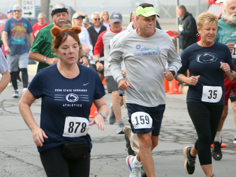 People running in the foreground and walking in the background