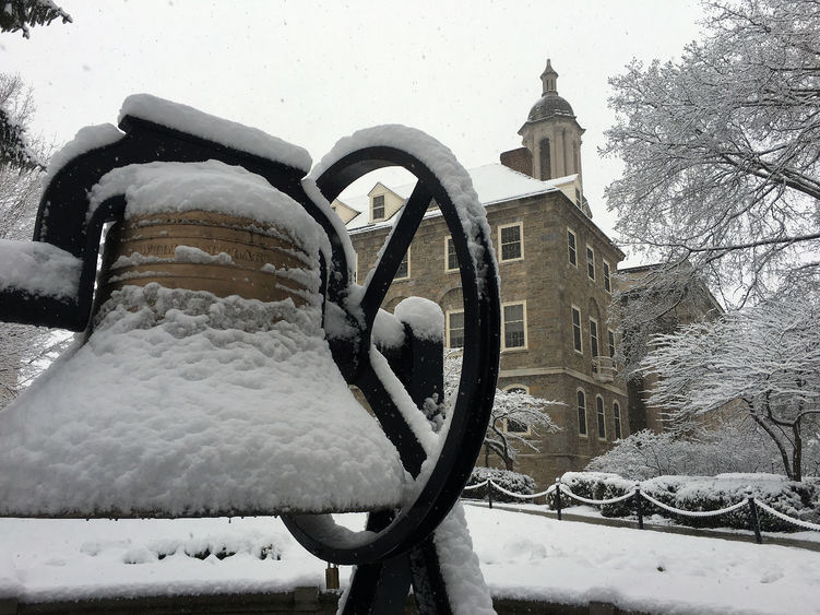 Snow falls on Old Main bell