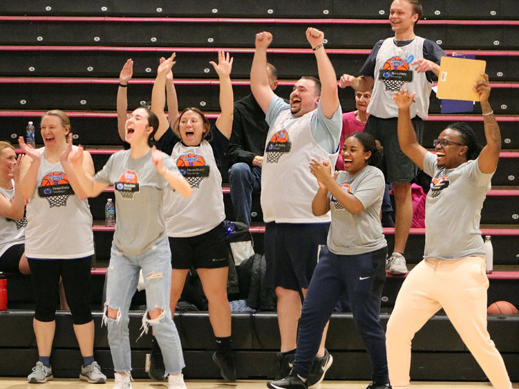 Group of people celebrating on a basketball court